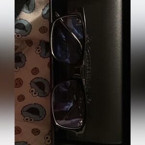 Chrome heart sunglasses . Black frame with silver detailing .
